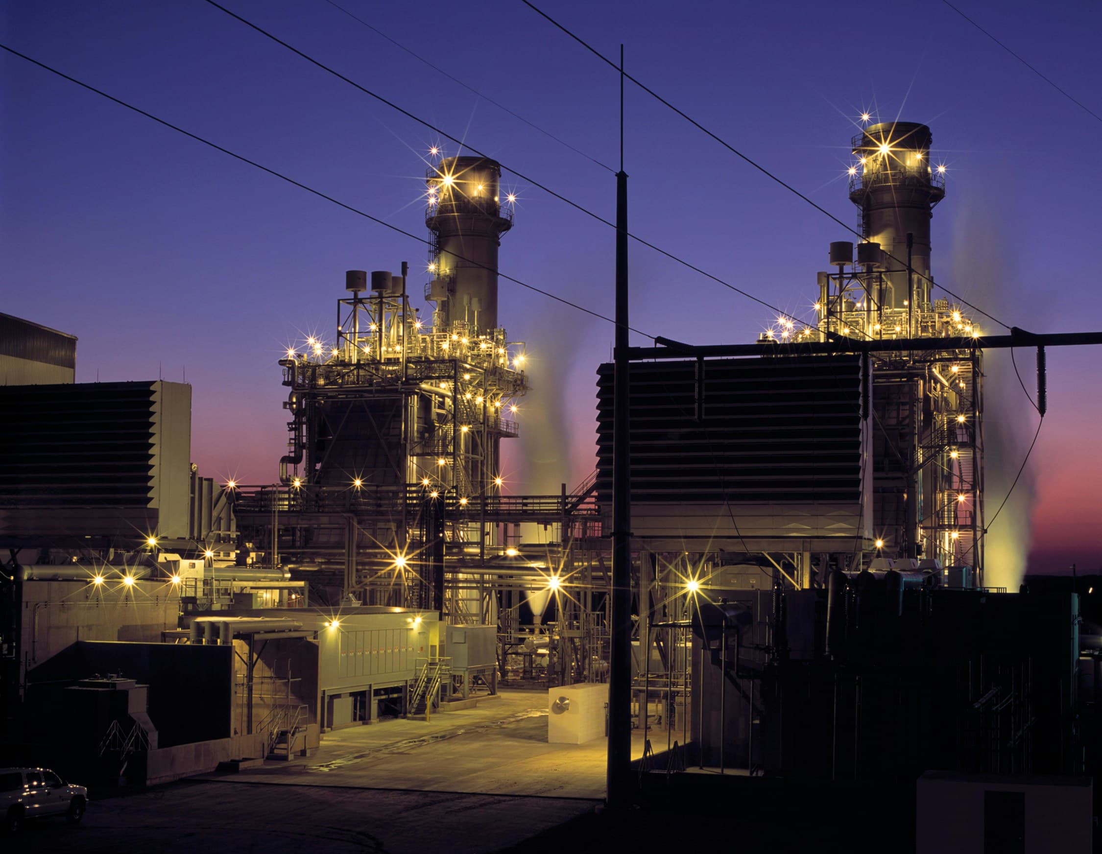 Natural gas power plant lit up at dusk